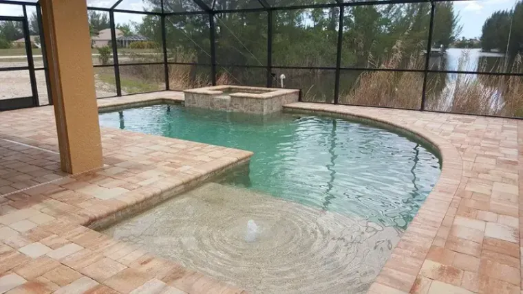 A waterfront pool and raised spa overlooking the lake