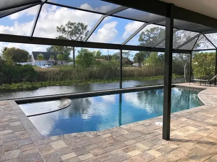 A wide shot of a screened pool on the canal