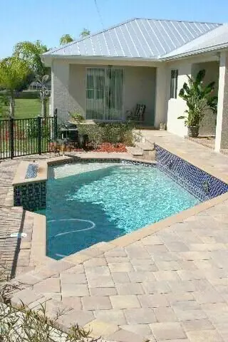 A compact screened pool and raised spa
